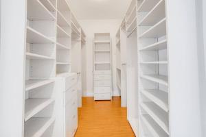 a white closet with white shelves and a wooden floor at Prime location! House w/pool 7 mins to Universal, 10 mins to Hollywood in Los Angeles