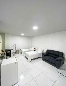 a living room with two beds and a couch at Apê 202 in Brasilia