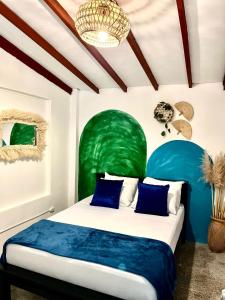 a bedroom with a bed with a green headboard at Spring Hostel in Medellín