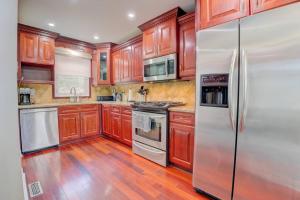 a kitchen with wooden cabinets and stainless steel appliances at Newly Renovated Detached Home in Brampton