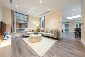 a living room with a couch and a table at Candler Mews in Twickenham