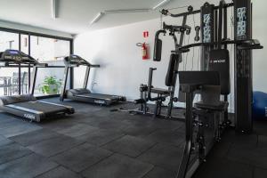 a gym with several tread machines in a room at Studio encantador em Poços de Caldas-MG PGO209 in Poços de Caldas