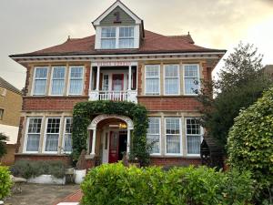 a large brick house with a red door at The Sandrock in Clacton-on-Sea