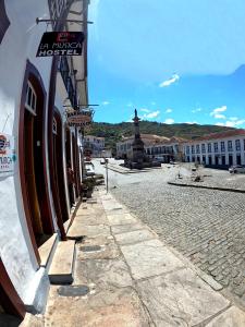 a street in a town with a sign on a building at La Musica Hostel OuroPreto in Ouro Preto