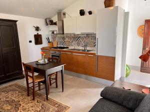 a kitchen with a table and a kitchen with a stove at La Fontanella Country House in Celle sul Rigo