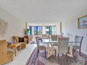 a living room with a dining table and chairs at Beachfront Ocean View Condo Beach Service 520 in Miami Beach