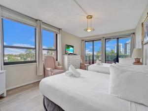 a bedroom with two beds and a large window at Beachfront Ocean View Condo Beach Service 520 in Miami Beach