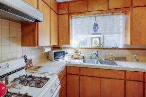 a kitchen with a stove and a sink and a microwave at Phoenix Home with Patio Near Downtown and Light Rail! in Phoenix