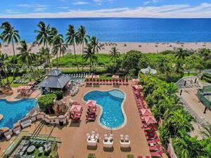an aerial view of a resort with a pool and the beach at Beachfront Condo w Beach Service 1207 in Miami Beach