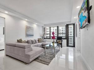 a living room with a couch and a table at Amazing Ocean View Condo Beach Service 1111 in Miami Beach