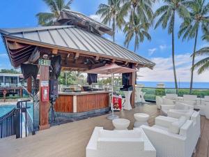 a bar with white furniture and a swimming pool at Amazing Ocean View Condo Beach Service 1111 in Miami Beach