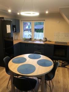 a kitchen with a table with blue circles on it at Apartament Nadwodnia 37 in Łapsze Niżne
