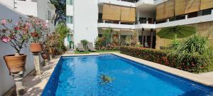 ein Swimmingpool mitten in einem Gebäude in der Unterkunft Apartment Tortugas - rooms with AC and great pool at 5 min from Carrizalillo beach and Benito Juarez Bulevard in Puerto Escondido