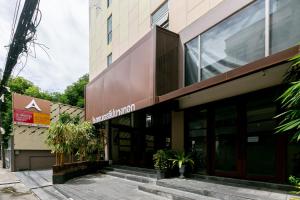 a building with a sign on the front of it at A Sleep Bangkok Sathorn in Bangkok
