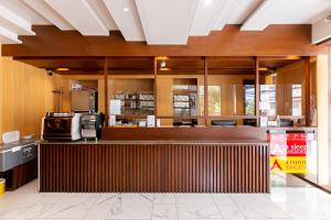 a restaurant with a counter with a microwave at A Sleep Bangkok Sathorn in Bangkok