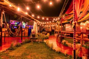 a stage with lights and plants on it at Valle verde, Hostel & camping in Urubamba