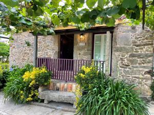 a stone house with a bench in front of it at Casa Velha-SantiagoFamilyHouse in Sever do Vouga