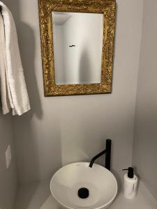 a bathroom with a white sink and a mirror at Casa Velha-SantiagoFamilyHouse in Sever do Vouga +18 photos