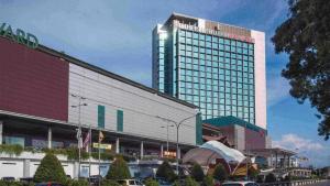 a large building in front of a parking lot at The Floorspace Imperial Suites Apartment 2 in Kuching