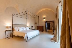 a bedroom with a bed with a metal canopy at Aurora apartment in Alma Domus in Amalfi