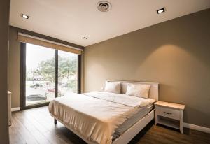 a bedroom with a bed and a large window at Accra Pearl in City in Accra