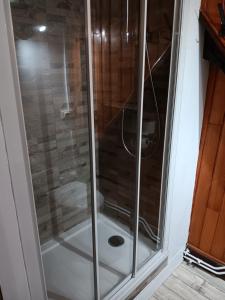 y baño con ducha y puerta de cristal. en hotel du Nord, en Brassy