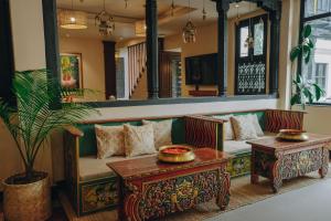 a living room with a couch and a table at SWARGA HERITAGE HOTEL - A TRADITIONAL STAY in Kathmandu