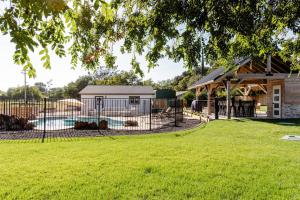 a large yard with a fence and a house at Beautiful spacious guest home in Roseville