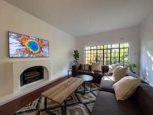 a living room with a couch and a fireplace at Riverside House with Indoor Pool in Johannesburg