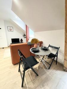 a dining room with a table and two chairs at /Sacré studio/Parking privé/Wifi in Rodez