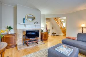 a living room with a couch and a fireplace at Cozy Westcott Home about half Mi to Syracuse Campus! in Syracuse