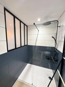 a bathroom with a glass shower with a sink at /Sacré studio/Parking privé/Wifi in Rodez