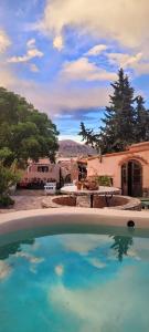 a pool of water in front of a house at Los Arcabuceros Posada Boutique in Tilcara