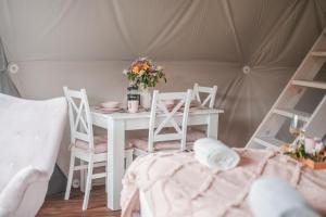 stół i krzesła w pokoju z namiotem w obiekcie Glamping Bobrowniczki w Kotlinie Kłodzkiej w Szczytnej