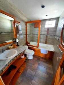 a bathroom with a sink and a tub and a toilet at Casa Ocean Pier in Puerto Ayora