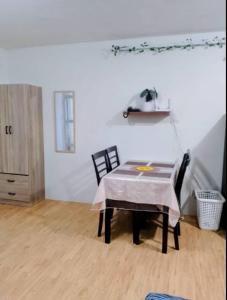 a dining room with a table and two chairs at Cozy Condo in Davao City