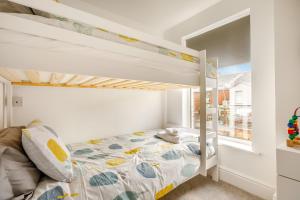 a bedroom with a bunk bed and a window at Keeling in Exmouth