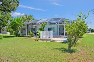 a house with a greenhouse in a yard at Port of Call in Port Charlotte