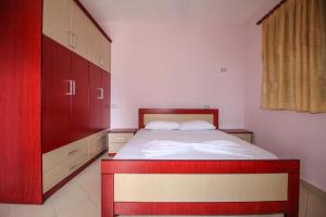 a bedroom with a bed and a dresser at Zak's Apartments in Ksamil