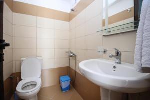 a bathroom with a toilet and a sink at Zak's Apartments in Ksamil