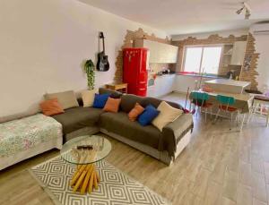 a living room with a couch and a table at Cozy appartament sea view in Marsaskala