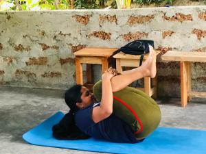 a woman doing a plank on a yoga ball at a table at Sethumka Ayurveda & Yoga Resort in Wadduwa