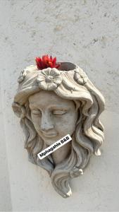 a statue of a woman with a flower on her head at Mphagahle B&B in Mthenti