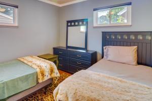 a bedroom with two beds and a mirror at Royal Oak Home 13 Mi to Downtown Detroit in Royal Oak