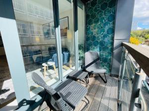a balcony with two chairs and a table at The Farringdon Flat in London