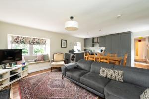 a living room with a couch and a dining room at Delightful Garden Upper Cottage in Oldhamstocks in Cockburnspath