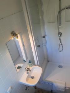 a white bathroom with a sink and a shower at kleine und charmante Monteurs Unterkunft B in Karlsruhe