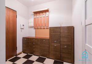 a dressing room with a wooden cabinet and a dresser at Pane Room in Gdańsk