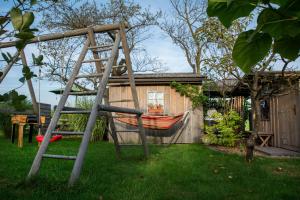 a hammock in a yard next to a house at Glamping with a view in Smlednik