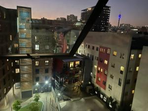 a view of a city at night with buildings at Cozy Life-style Apartment in Maboneg in Johannesburg